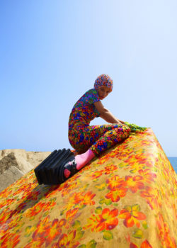model sitting in colorful clothes