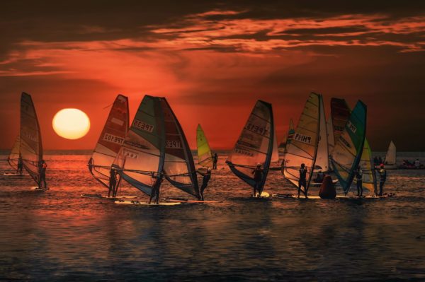 surfers in sunset